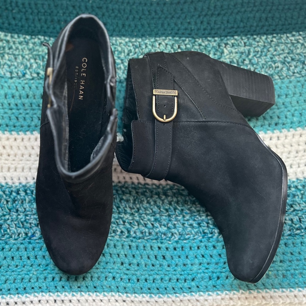 Cole Haan Black suede zip ankle boot with stacked heel, and buckle strap.